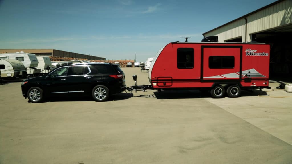 black 2019 chevy traverse towing a red winnebago micro minnie in red